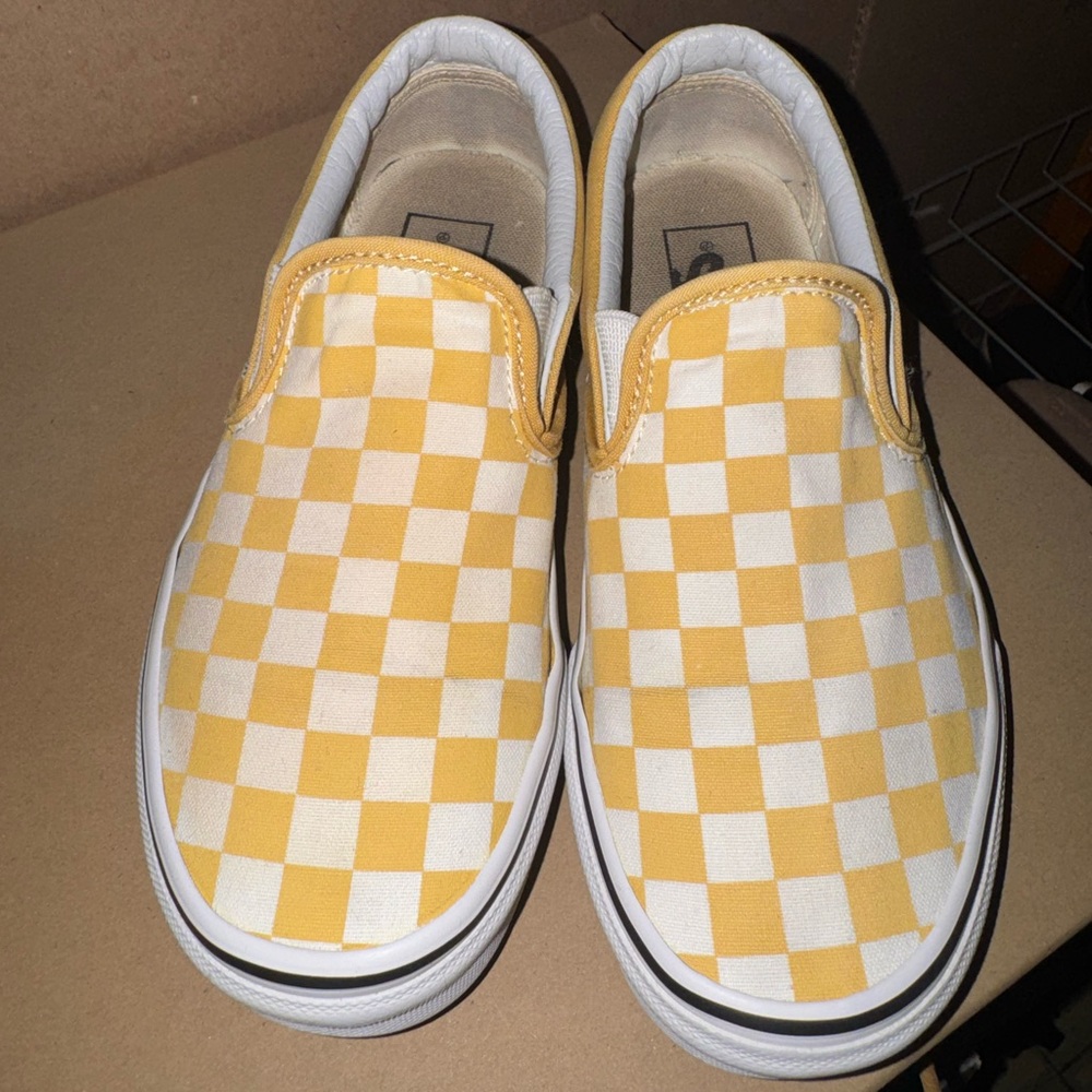 Yellow and white slip on vans